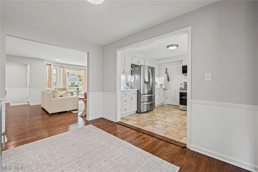 Hall featuring wood finished floors and baseboards