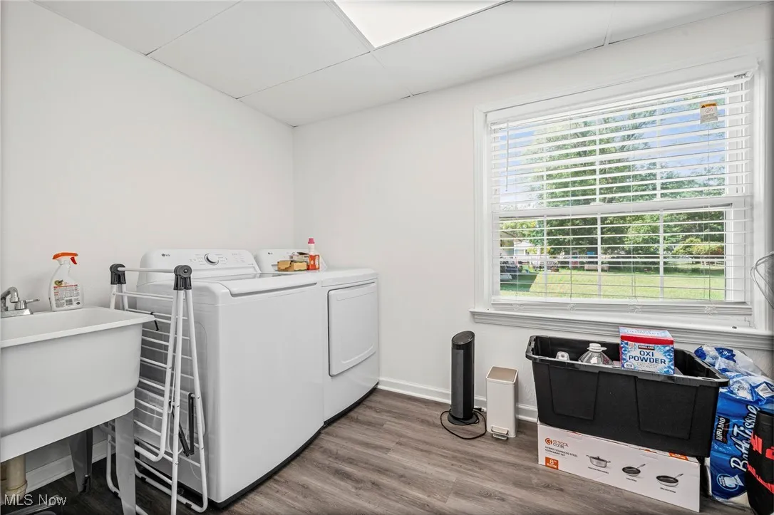 Laundry area featuring washer and dryer and wood finished floors