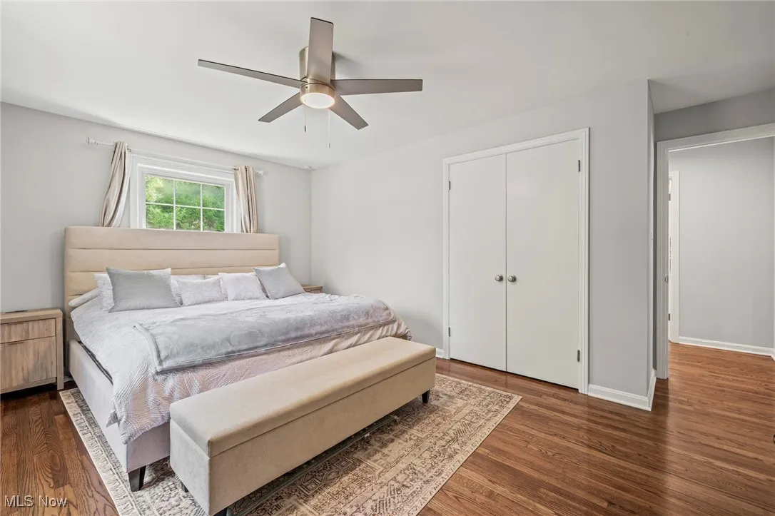 Bedroom featuring wood finished floors, ceiling fan, and a closet