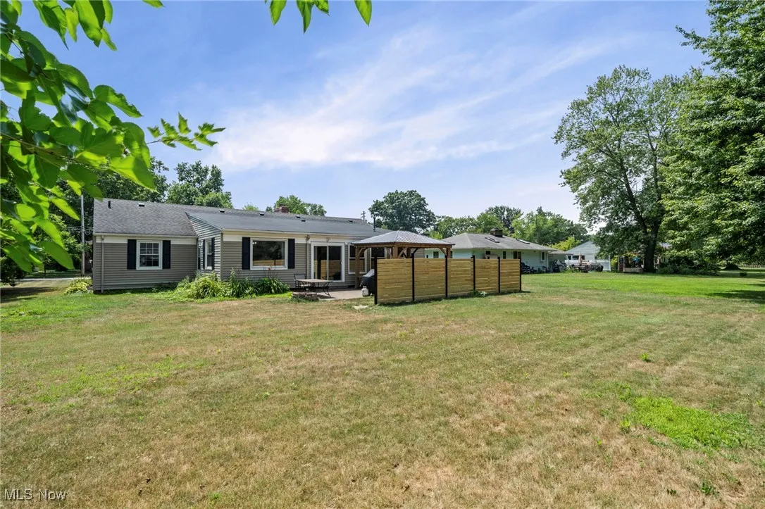 Back of house with a patio, a yard, outdoor lounge area, and a gazebo