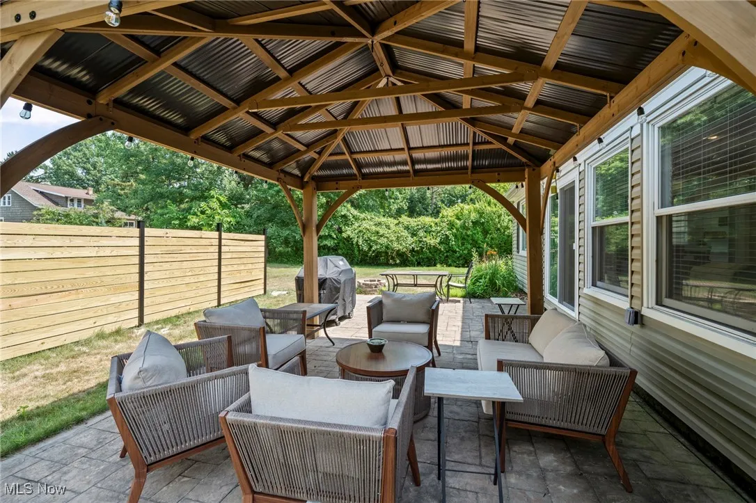 View of patio featuring an outdoor hangout area, grilling area, and a gazebo