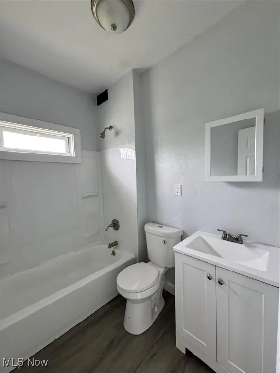 Full bathroom featuring vanity,  shower combination, and wood finished floors