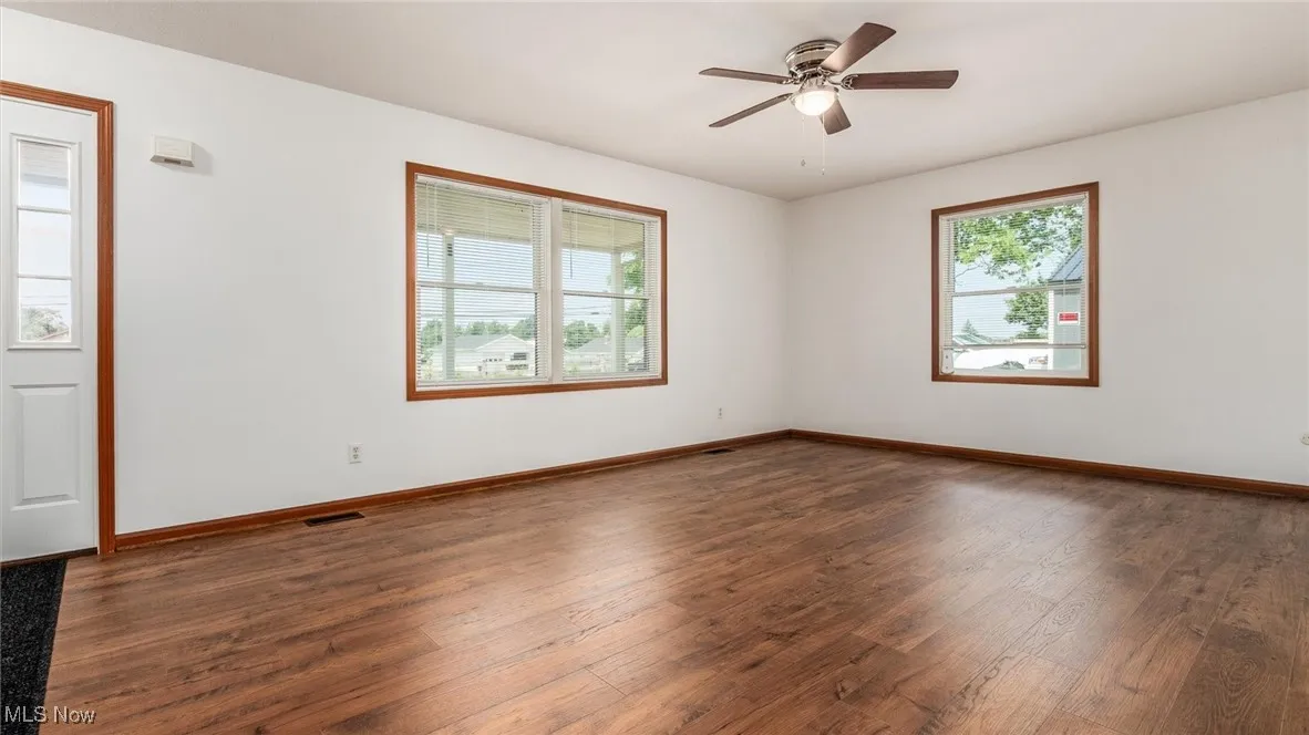 Spare room with wood-type flooring and ceiling fan