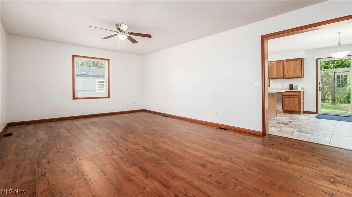 Unfurnished room with ceiling fan and light wood-type flooring