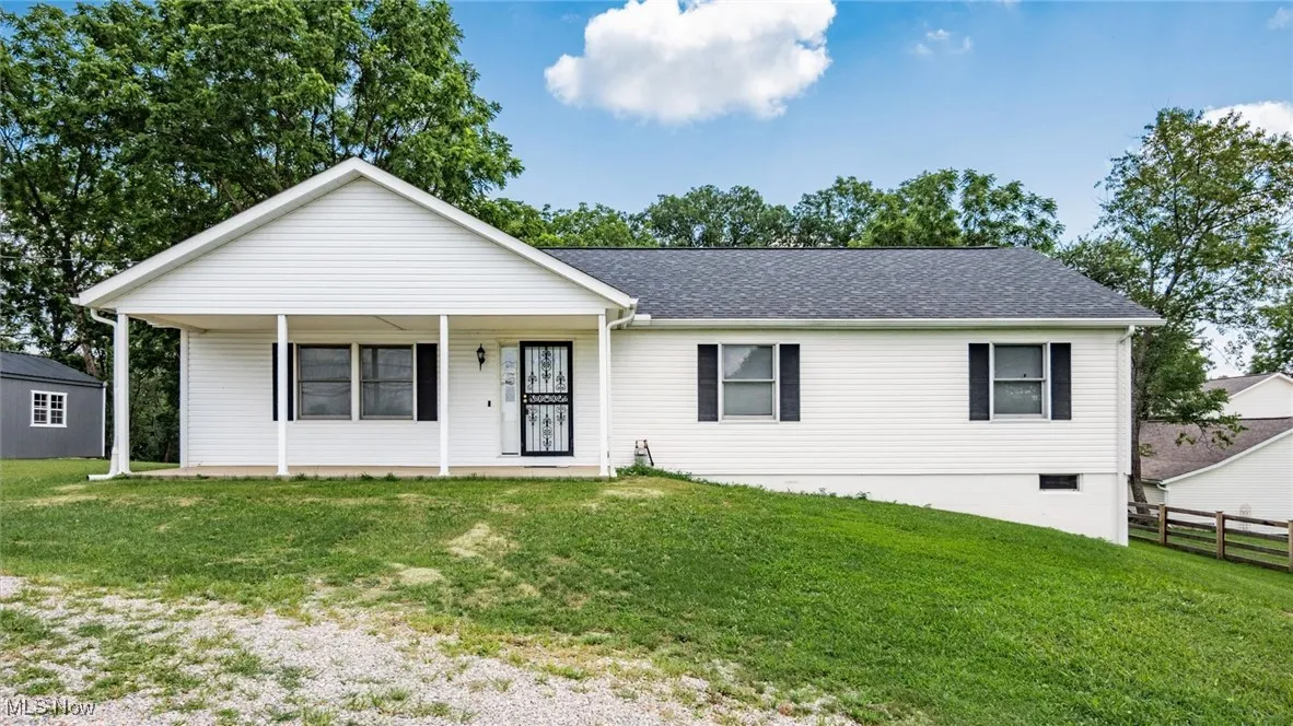 Ranch-style house with a porch and roof with shingles