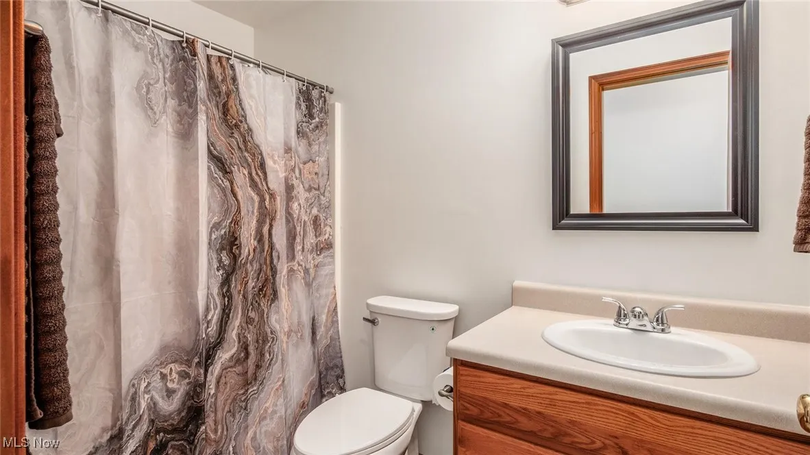 Full bathroom featuring vanity and toilet