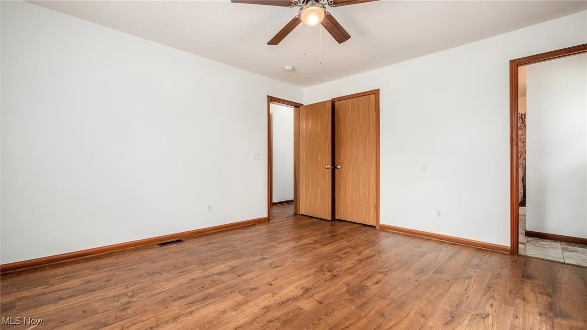 Unfurnished bedroom with wood finished floors and ceiling fan