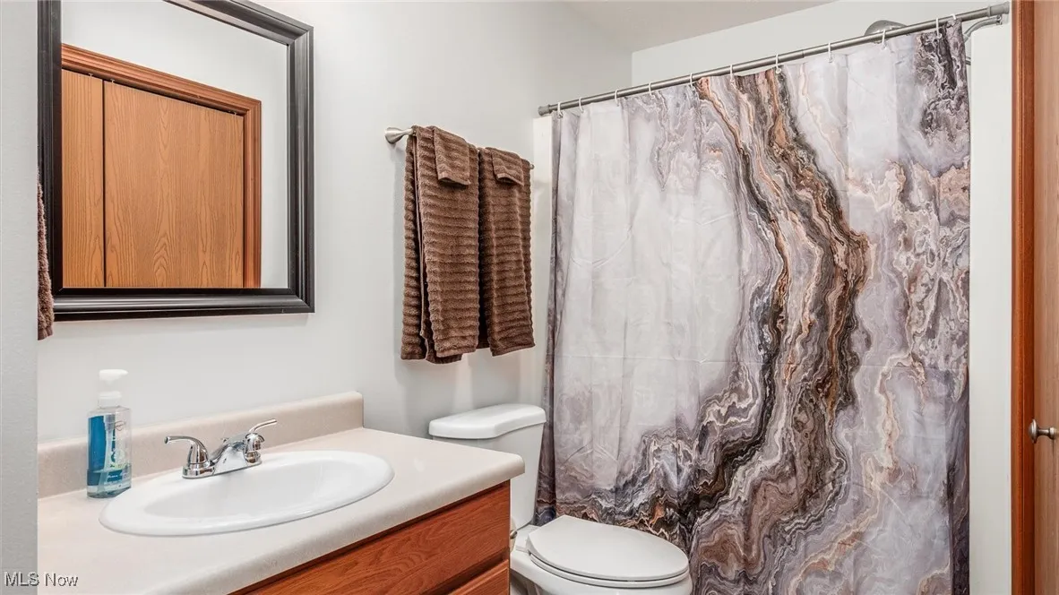 Bathroom with vanity and a shower with shower curtain