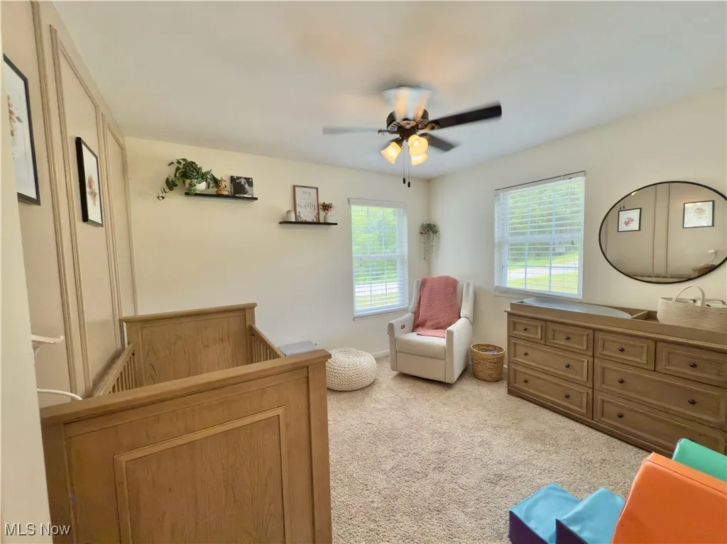 Carpeted bedroom with ceiling fan