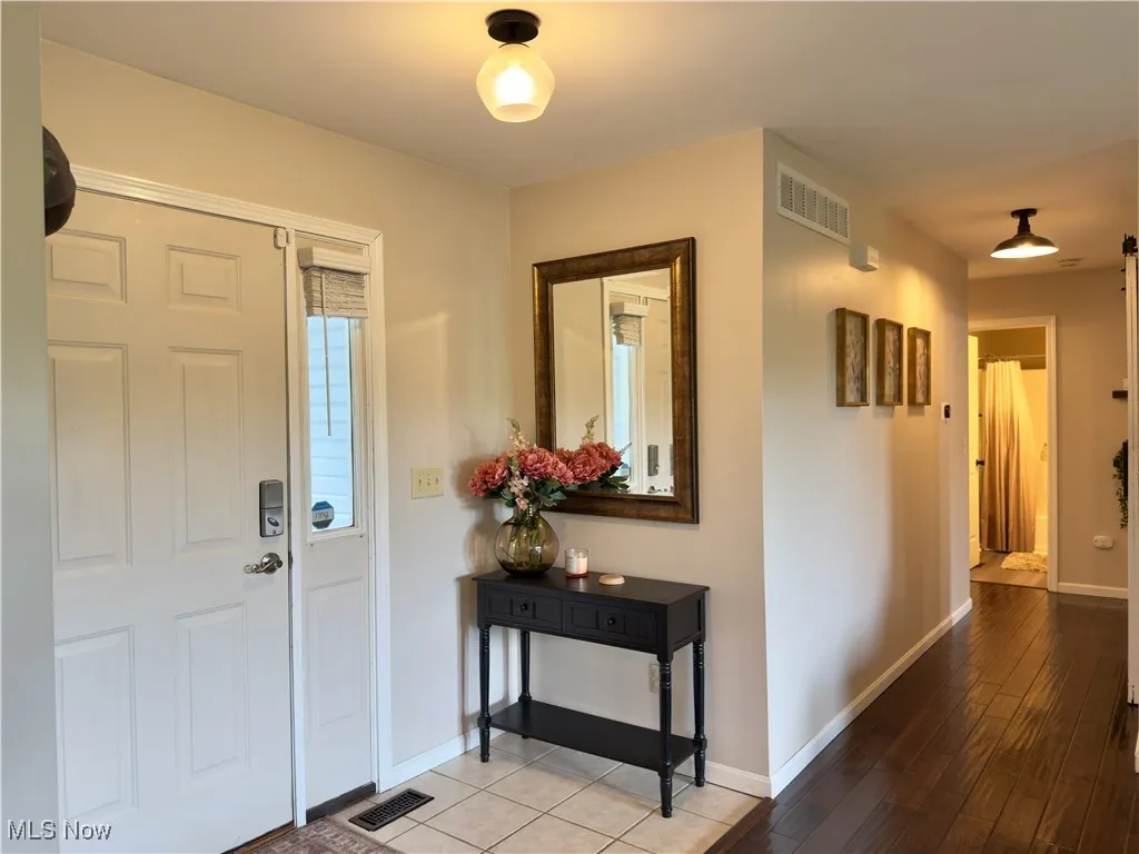Entryway with baseboards and wood finished floors