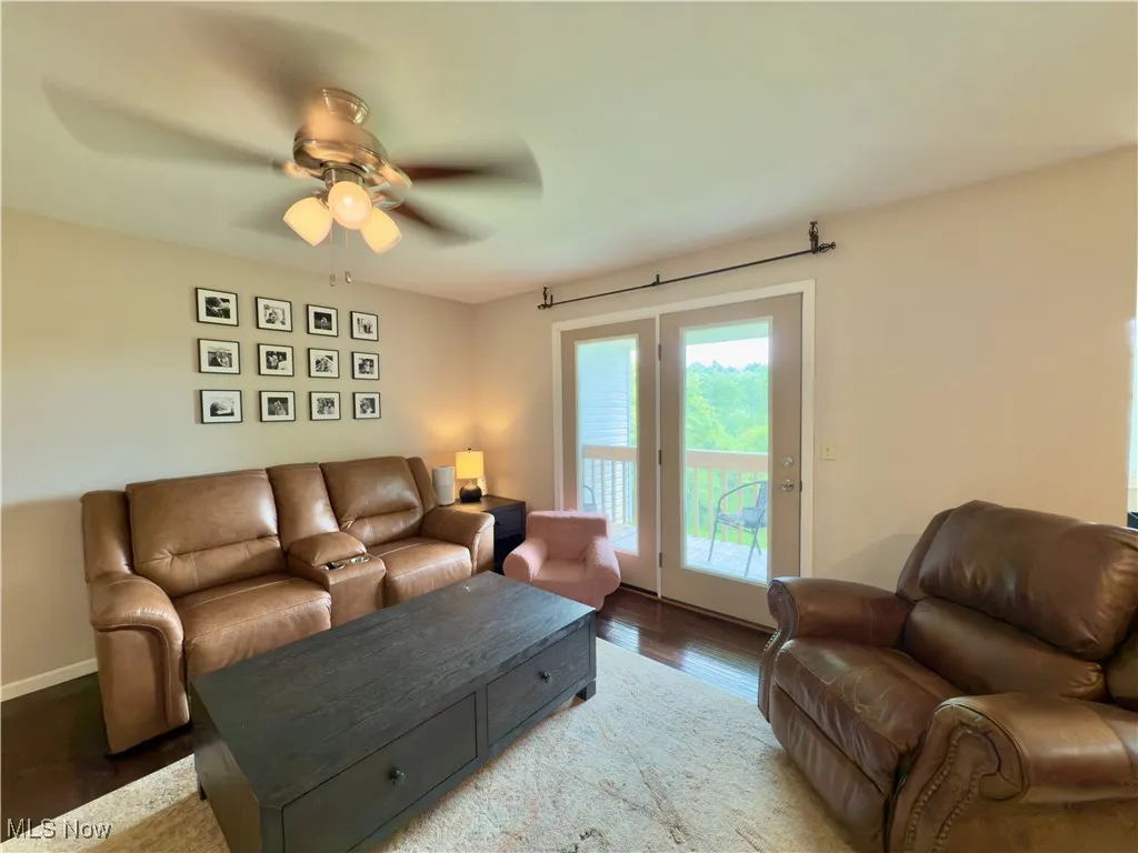 Living room with wood finished floors and a ceiling fan