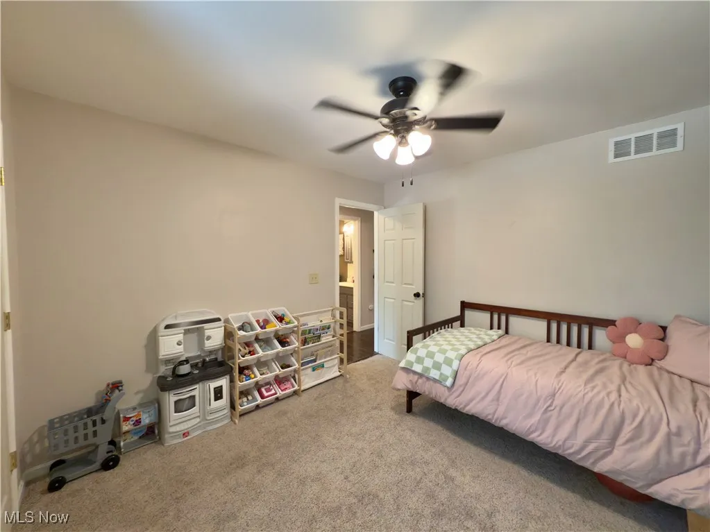 Bedroom featuring carpet and ceiling fan