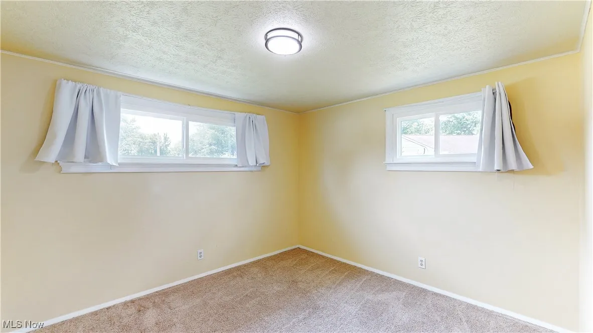 BEDROOM 1. FRESH PAINT & NEUTRAL CARPETING.