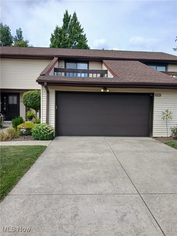 View of front of home featuring an attached garage and driveway