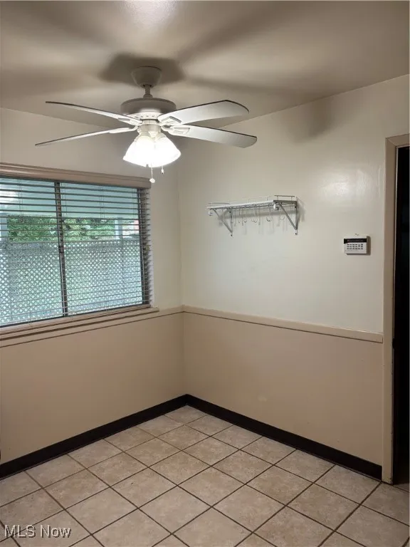 Eat in kitchen with  a ceiling fan and light tile patterned floors