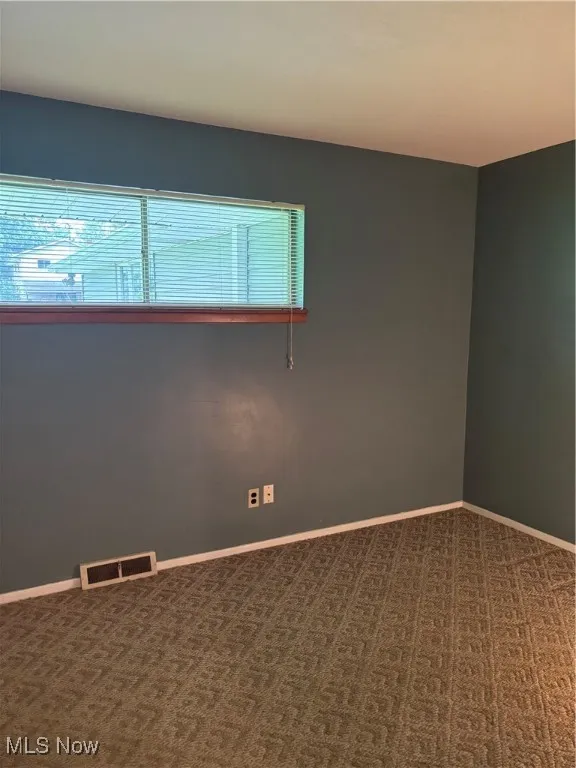 Carpeted bedroom room with baseboards