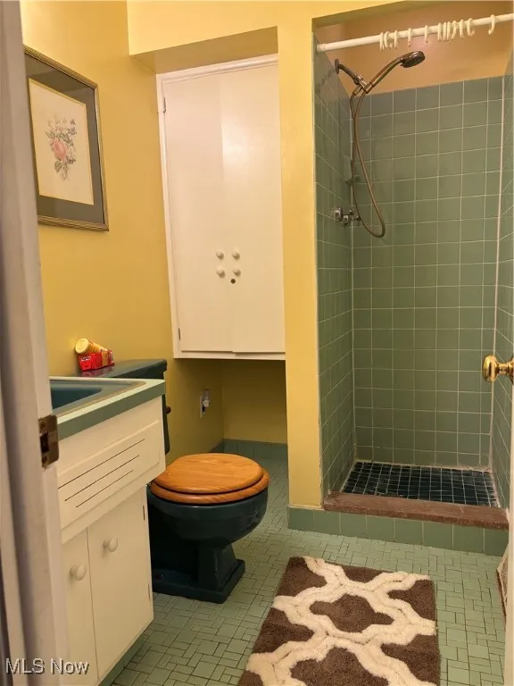 Primary Bathroom featuring a shower stall, vanity, and tile patterned floors