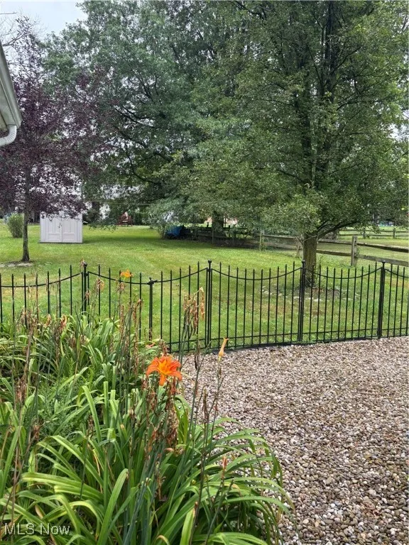 View of yard with a storage shed and a view of rural / pastoral area
