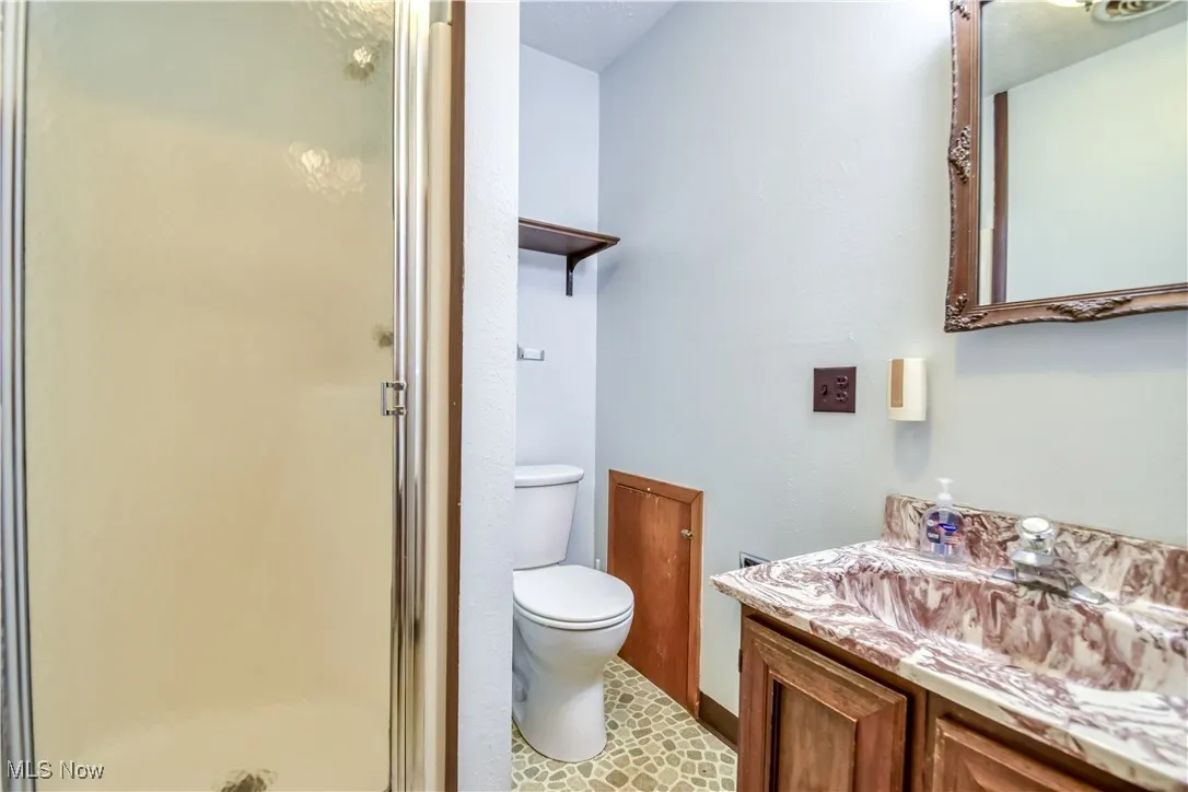Bathroom with vanity and a shower stall
