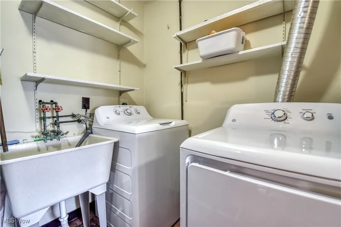 Washroom featuring washing machine and dryer