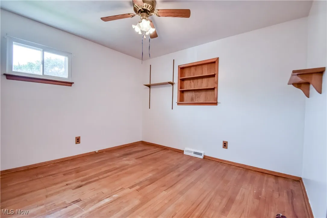 Spare room featuring light wood-style flooring and ceiling fan