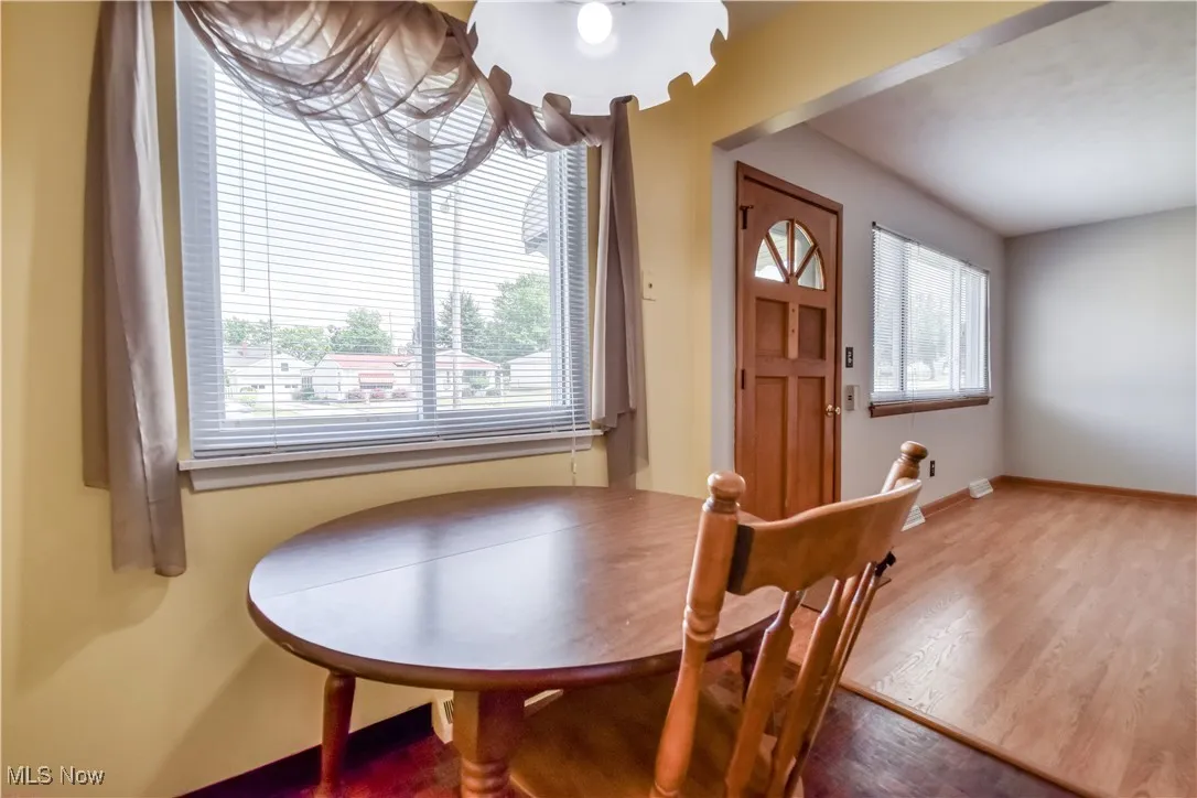 Dining space with wood finished floors and baseboards