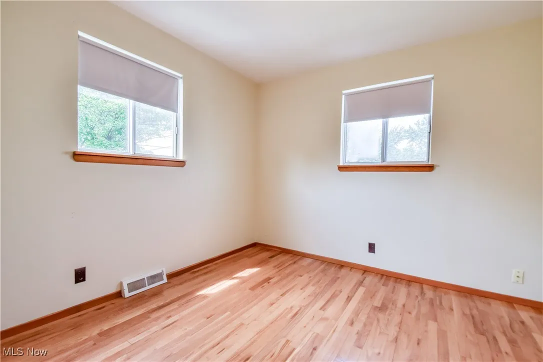 Unfurnished room featuring healthy amount of natural light and light wood finished floors