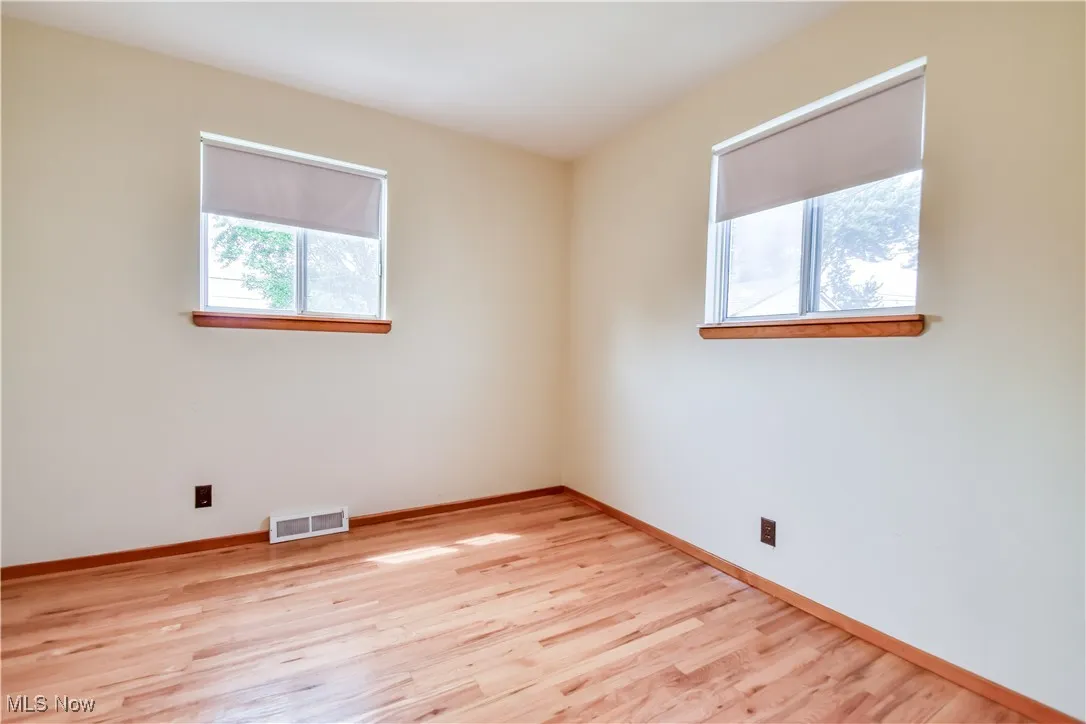Empty room featuring light wood-style floors and baseboards