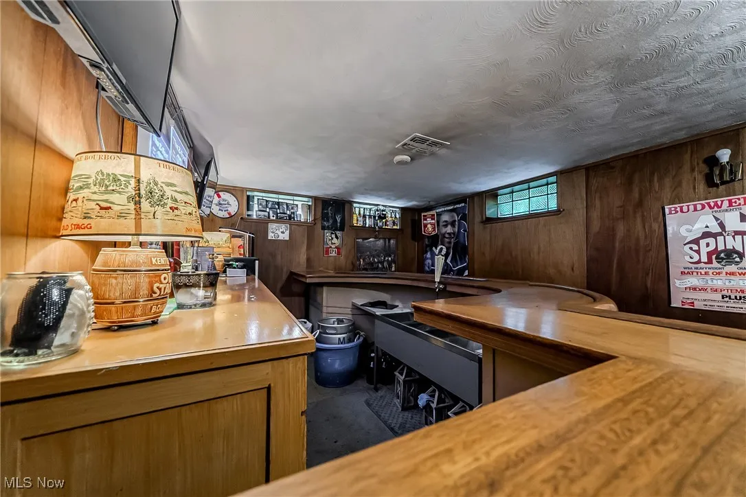 Indoor bar with wooden walls and a textured ceiling