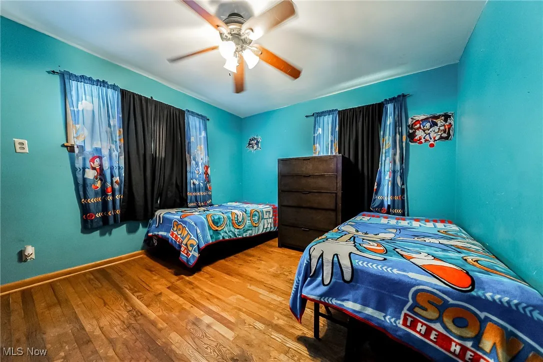 Bedroom featuring wood-type flooring and a ceiling fan