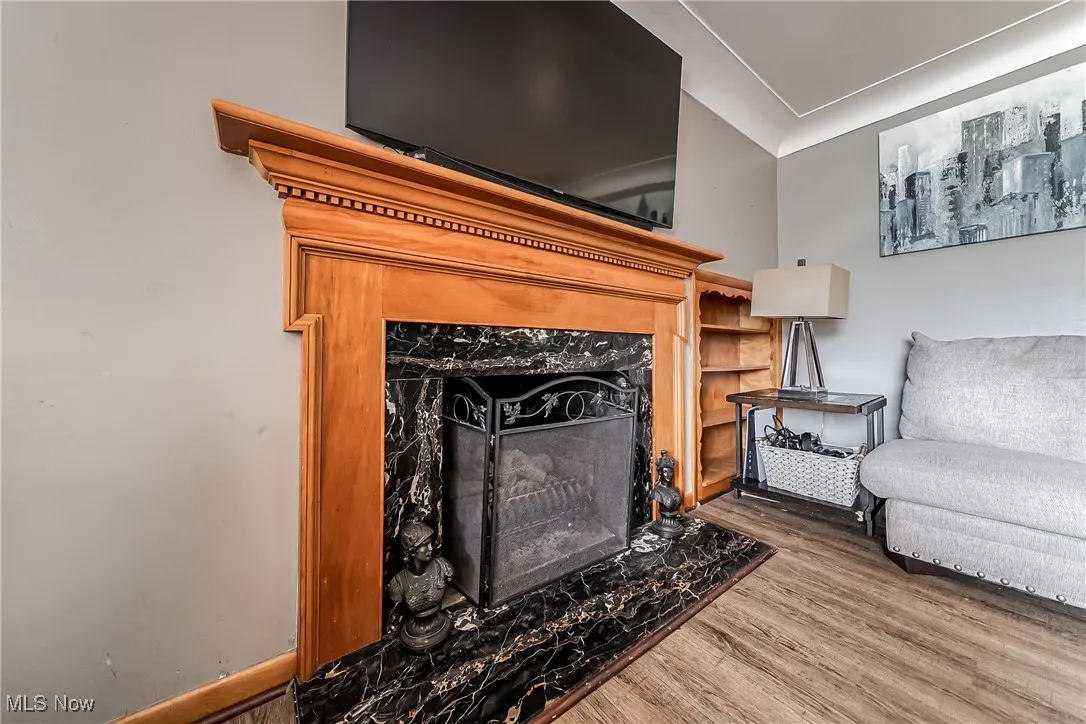 Living room featuring wood finished floors and ornamental molding