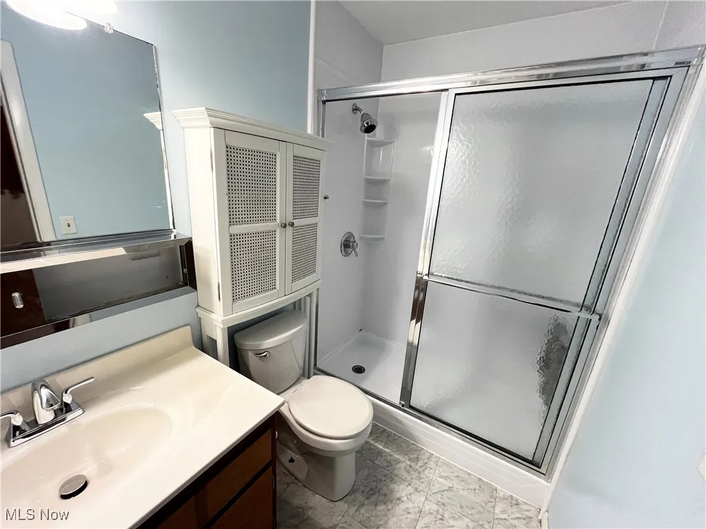 Bathroom with a shower stall and vanity