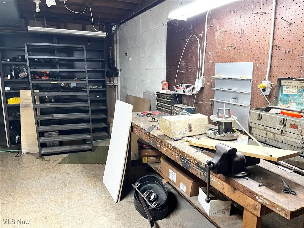 Garage with a workshop area and concrete block wall