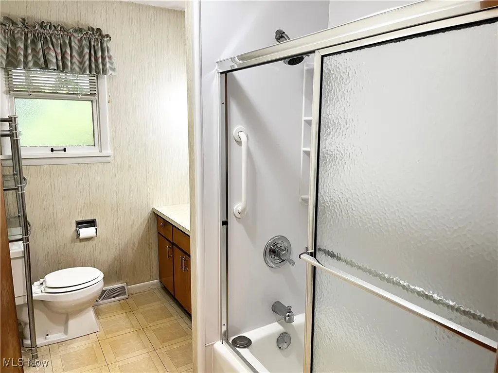 Full bath featuring vanity, bathtub / shower combination, and tile patterned floors