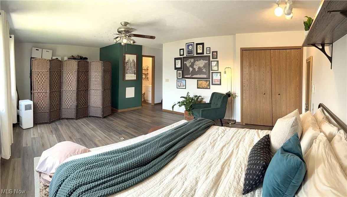 Bedroom featuring wood finished floors, a closet, and ceiling fan