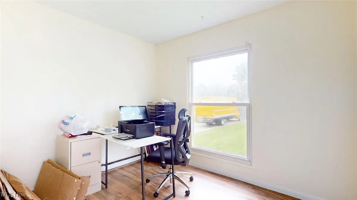 Office featuring wood finished floors and a baseboard radiator