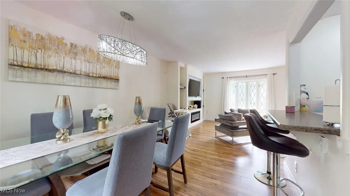 Dining area with wood finished floors and lots of light!