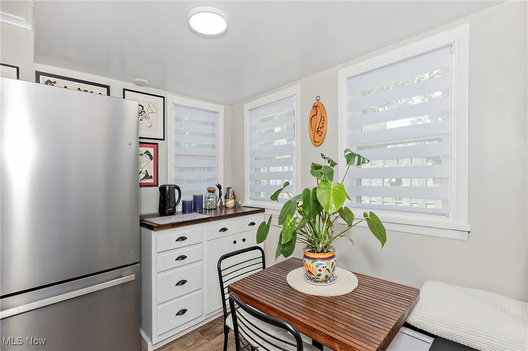 A nice view of the coffee / bar and eat in space in the kitchen, along another wall of newer windows and custom treatments.