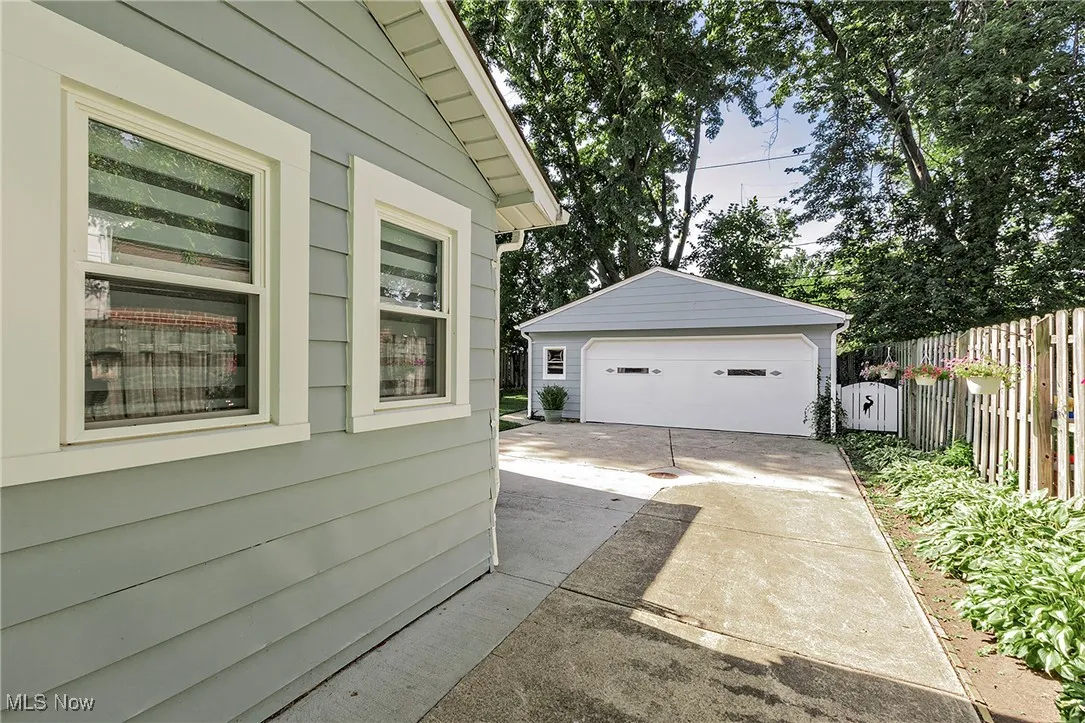A nice view of the oversized 2+ car garage and privacy fencing along the driveway!