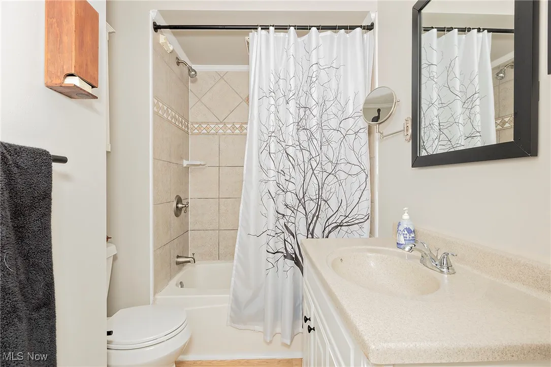 The full bath with fresh tile and vanity.