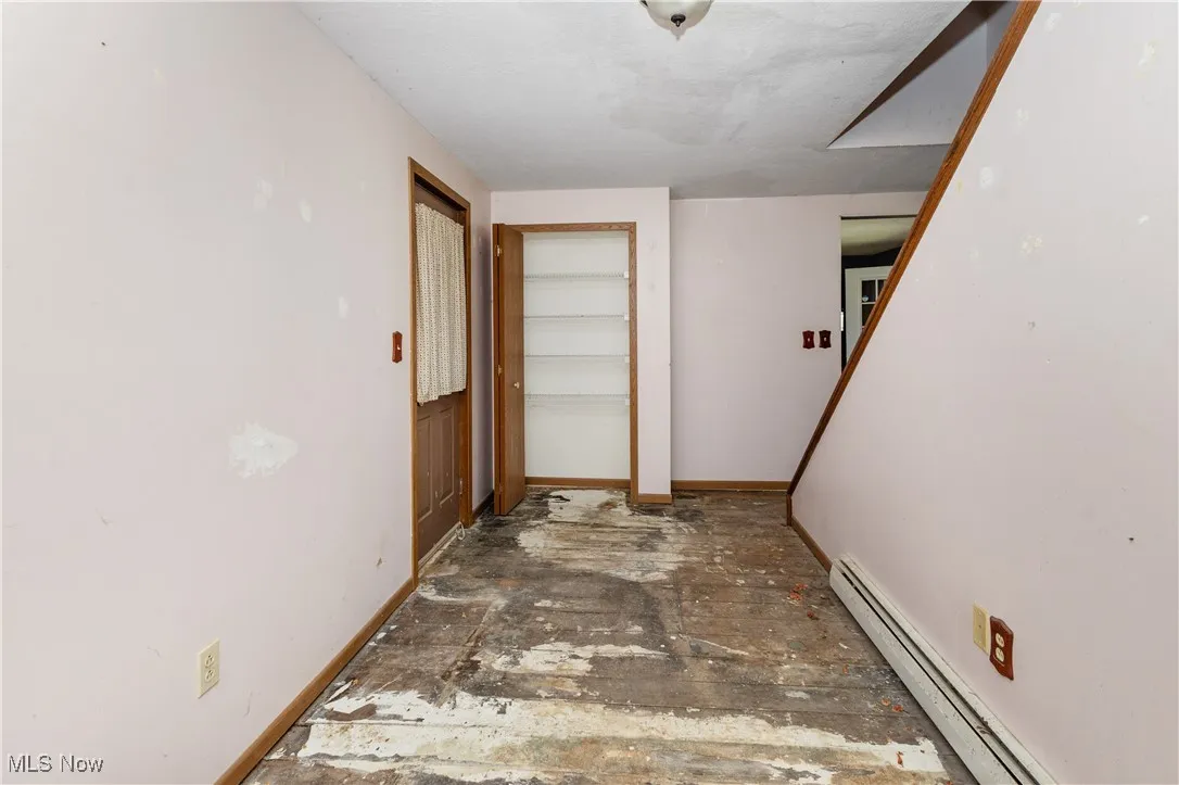 Entryway with a baseboard heating unit and baseboards
