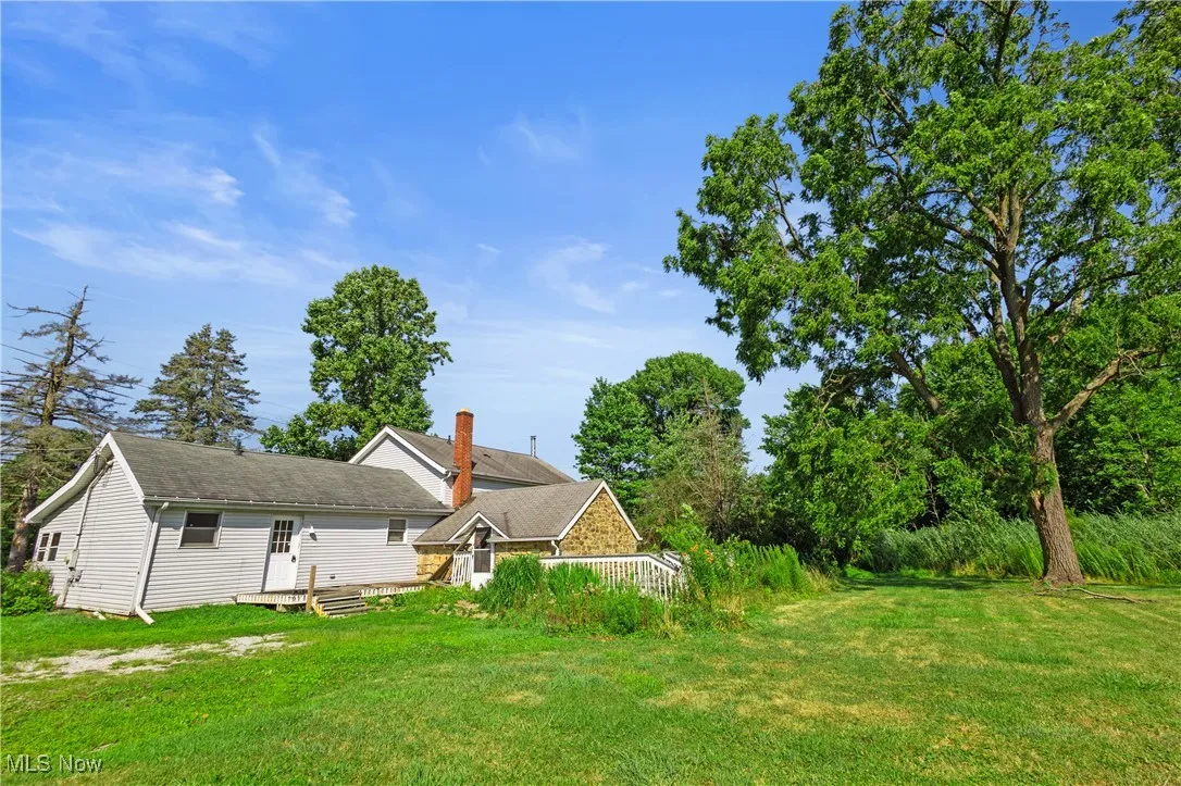 Rear view of house featuring a lawn