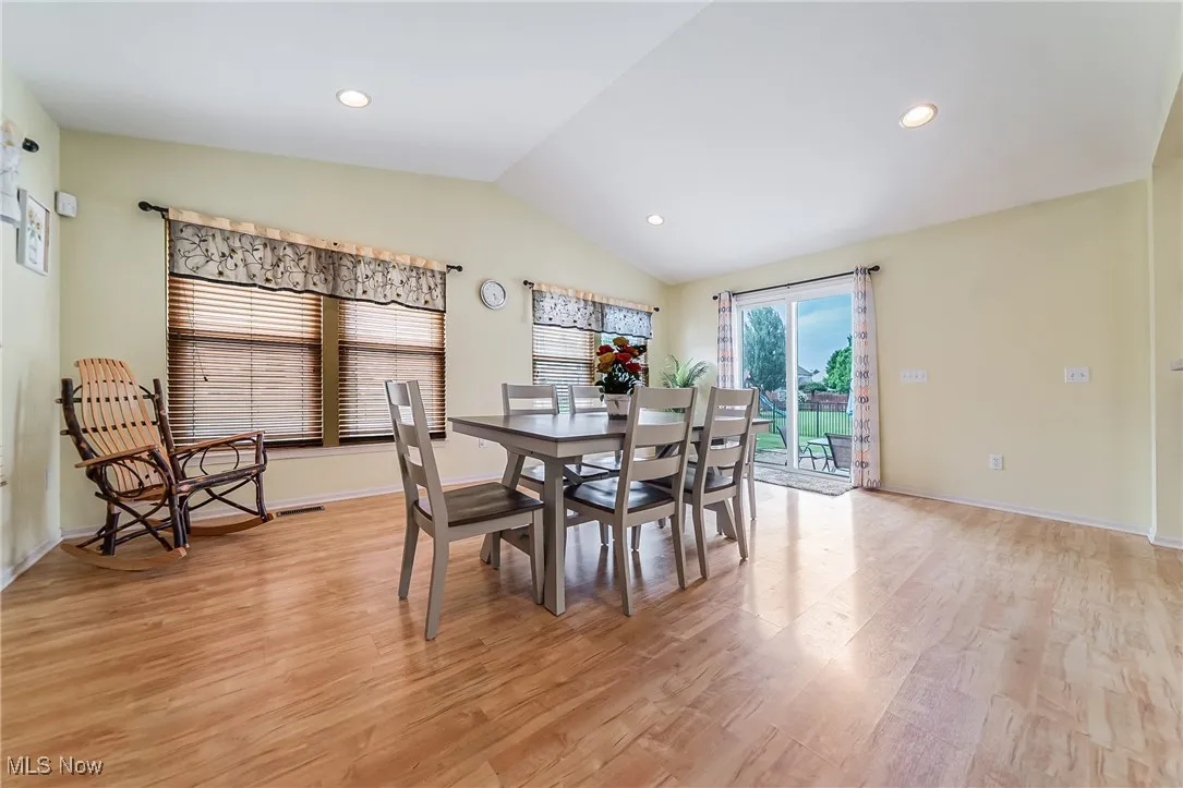 Dining space featuring vaulted ceiling, light wood-type flooring, and recessed lighting