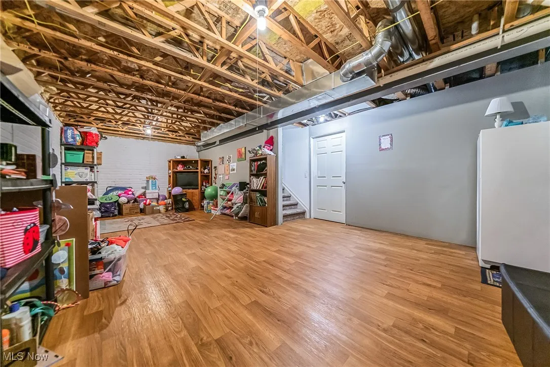 Basement featuring wood finished floors and stairs