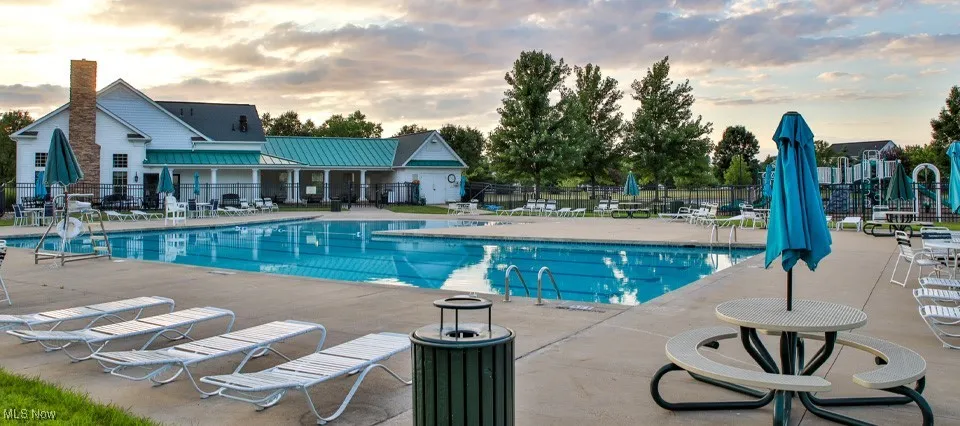 Community pool with a patio