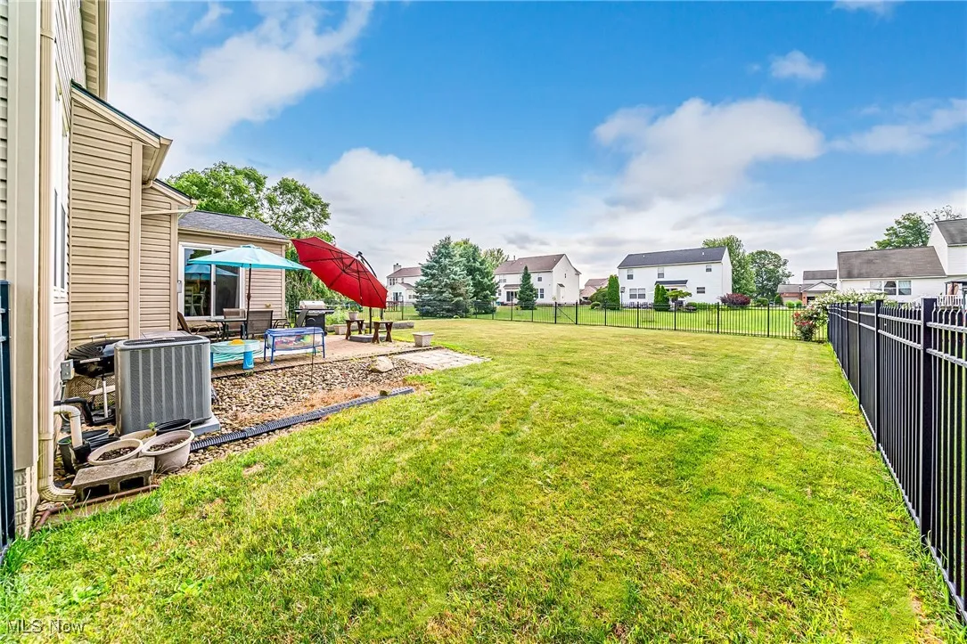 Fenced backyard with a patio and a residential view