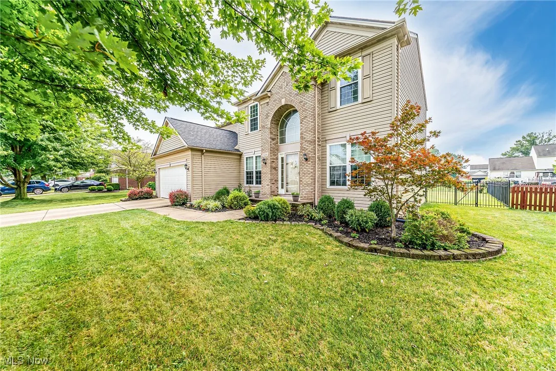 Traditional home featuring an attached garage and concrete driveway