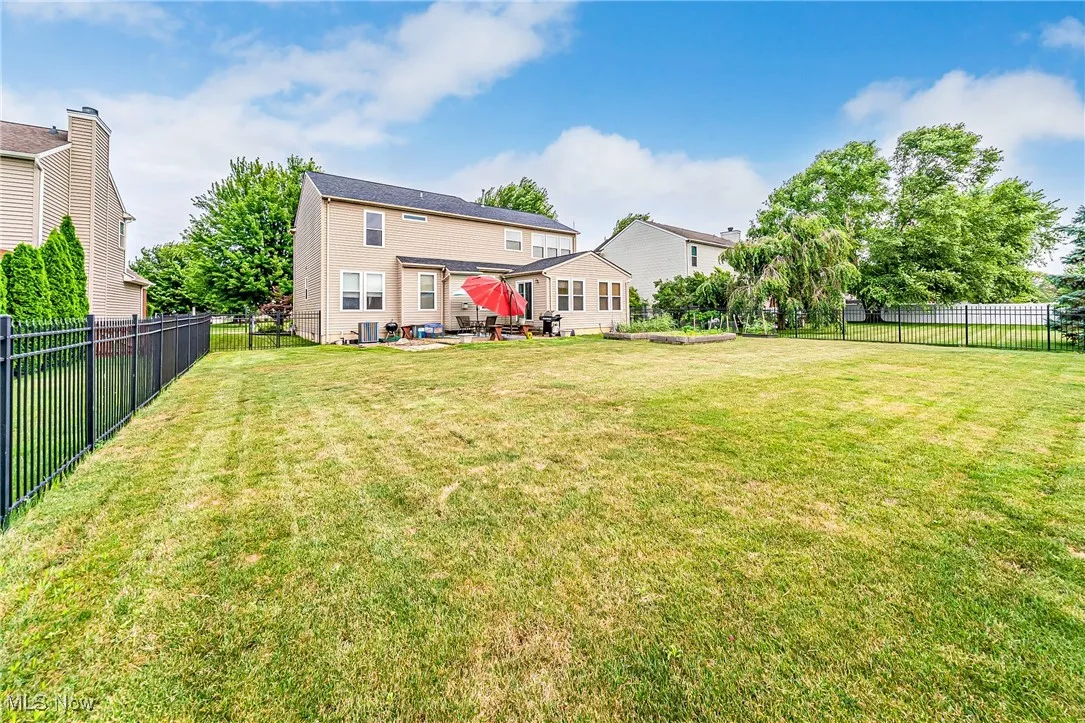 Rear view of property with a fenced backyard