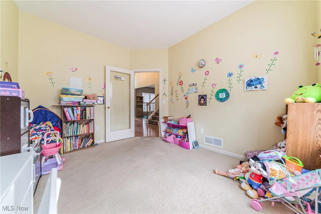 Game room with carpet floors and baseboards