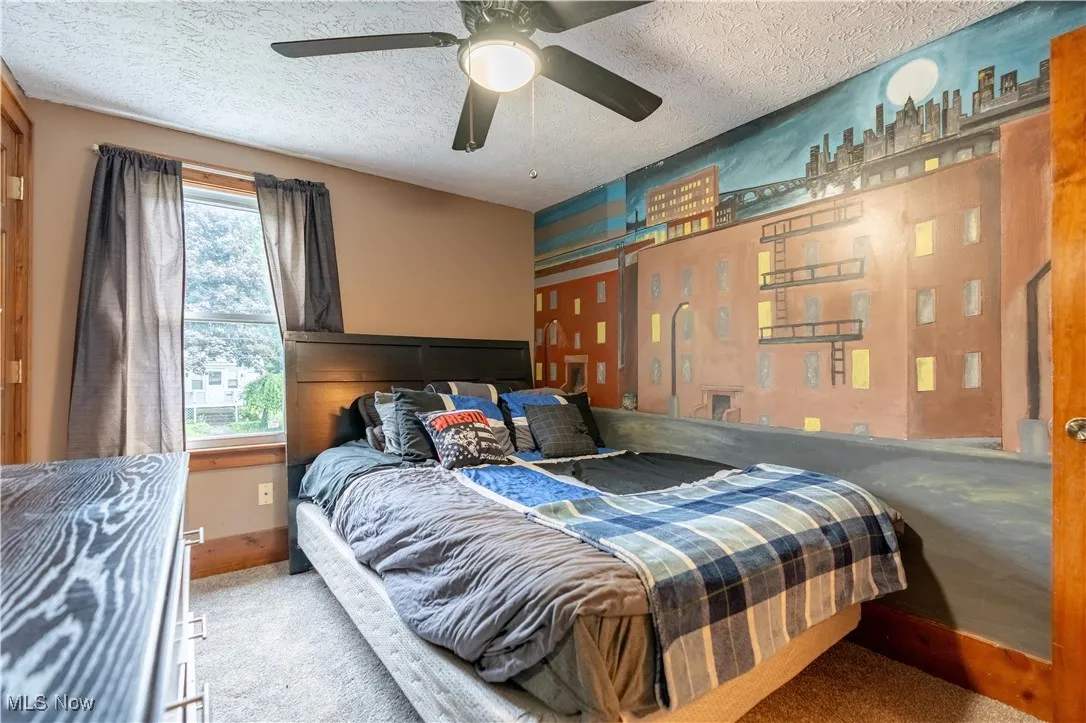Bedroom featuring a textured ceiling and carpet floors